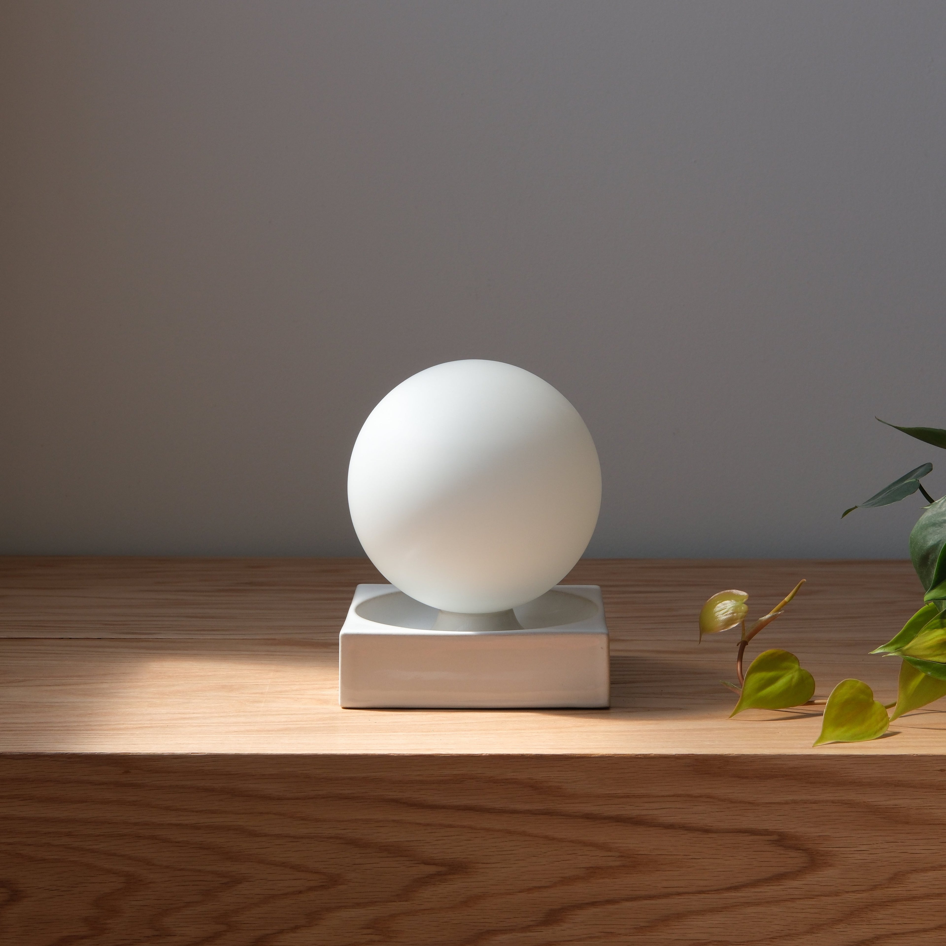 Cubic Table Lamp scale against framed art