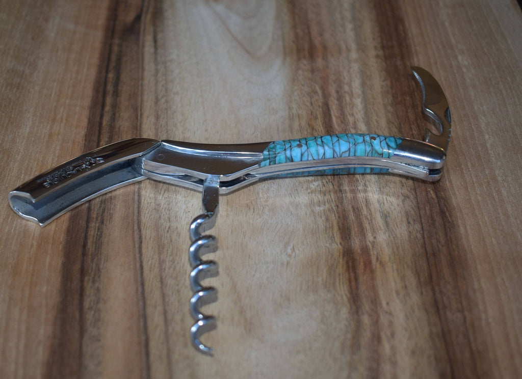 Corkscrew with the spiral open on a wooden board