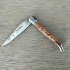 Laguiole ash burl folding knife half open on a grey wood surface