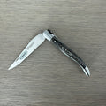 Laguiole grey pakka folding knife half open on a pale wood surface