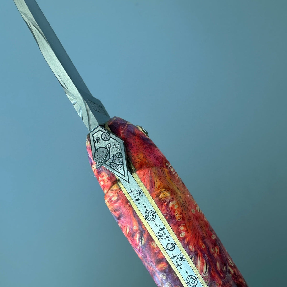 Close view of the forged bee and engraved spring
