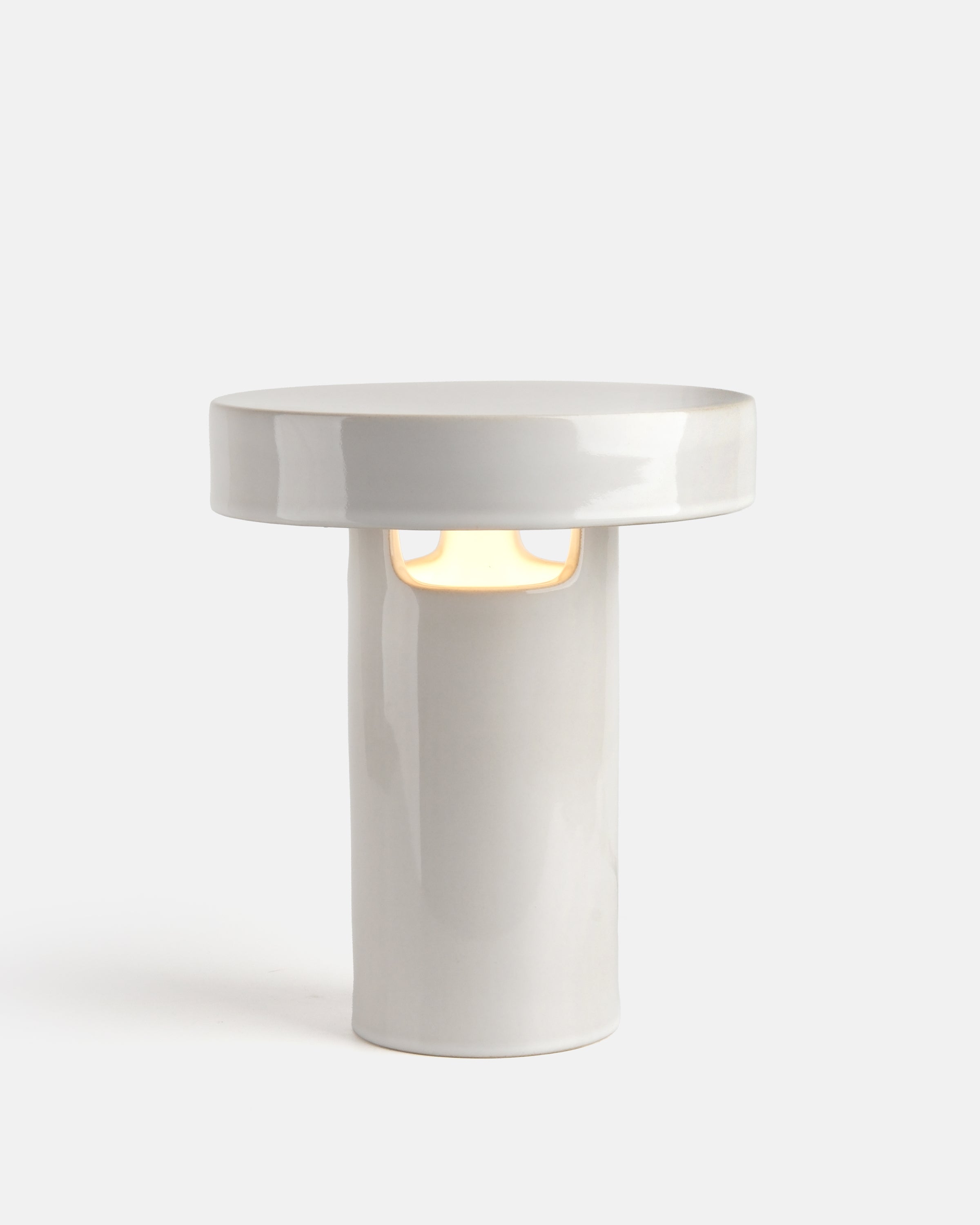 slip cast ceramic lamp in White Glossy on a bookshelf